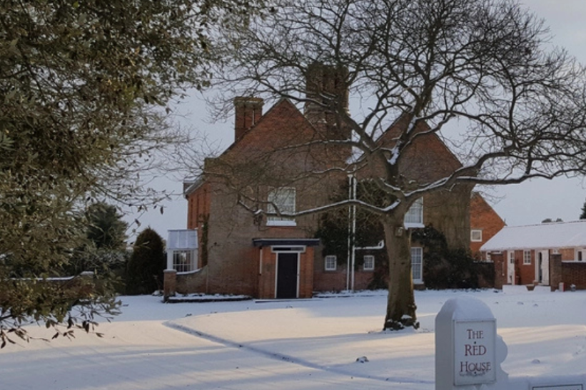 A red brick house in the snow