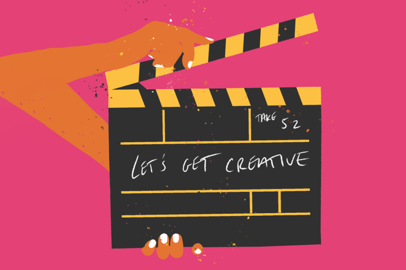 A film clap board on a pink background